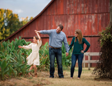 Family poses for fall family photos.