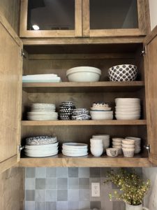 Organized dinnerware in a kitchen cabinet