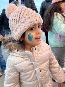 Young girl celebrates Chanukah during Downtown in December. 