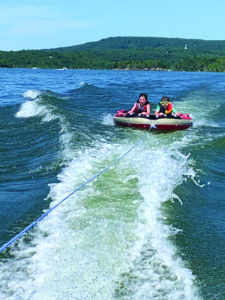 Two people riding on a tube in Lake Tenkiller
