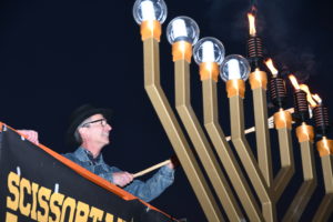 As the sun sets, organizers will light a giant menorah. at the OKC Community Chanukah Festival .